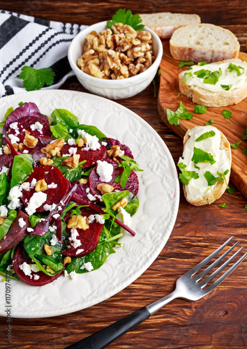 Healthy Beet Salad with fresh sweet baby spinach, kale lettuce, nuts, feta cheese and toast melted 