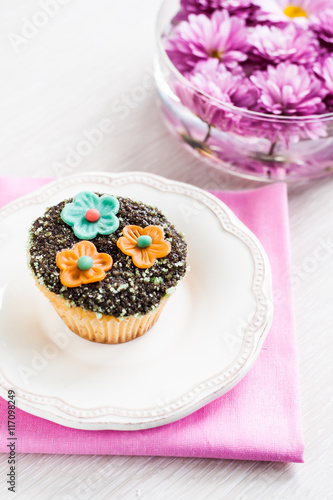 cupcake with chocolate ganache and decorated with flowers chrysa photo