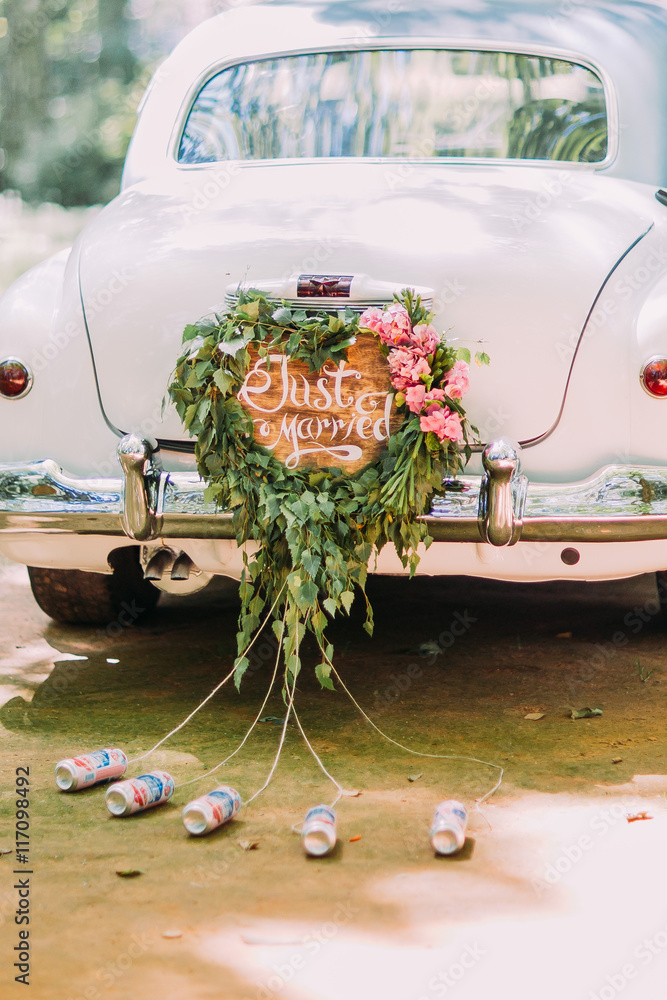 Vintage wedding car with just married sign and cans attached, close-up  Stock Photo | Adobe Stock