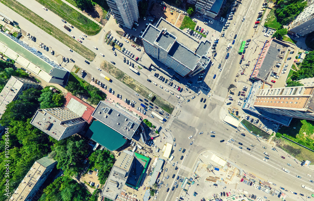 Aerial city view with crossroads and roads, houses, buildings, parks and parking lots, bridges. Urban landscape. Copter shot. Panoramic image. Aerial city view with crossroads and roads, houses, buildings, parks and parking lots, bridges. Urban landscape. Copter shot. Panoramic image.