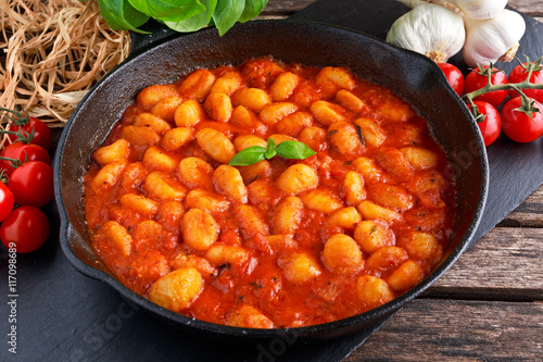 Homemade Italian Gnocchi with marinara sauce in iron pan