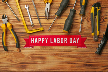 Happy Labor Day holiday and tools set on wooden background