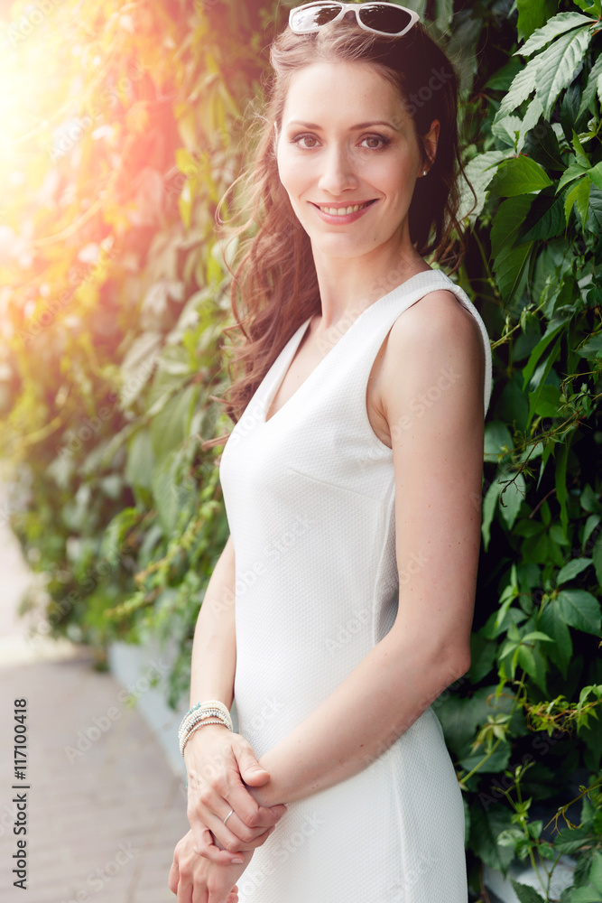 Portrait of young smiling girl with long brown curly hair Portrait of young smiling girl with long brown curly hair