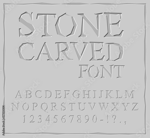 Stone Carved font. Alphabet on rock plate. Chips and scratches.