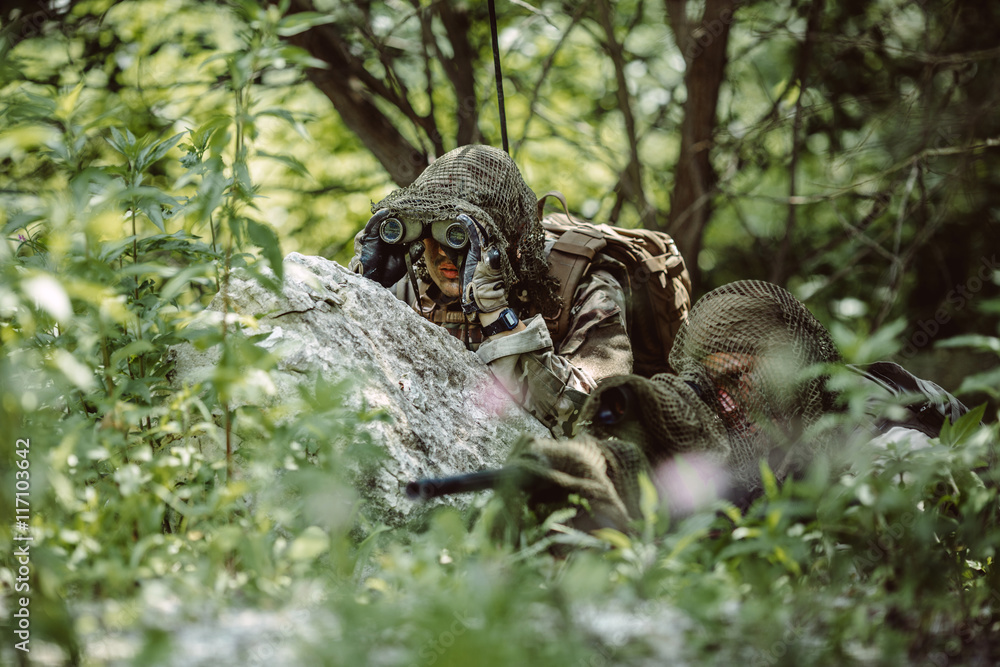 Obraz premium Army sniper during the military operation in the mountain. war,