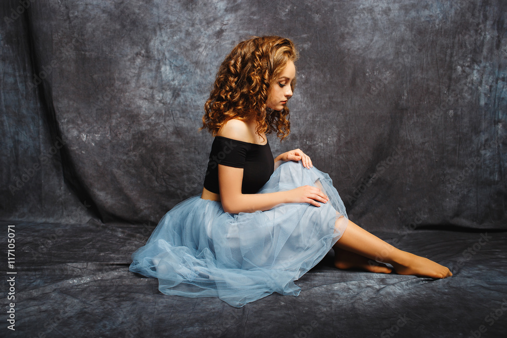 beautiful and delicate ballerina in a studio on gray background beautiful and delicate ballerina in a studio on gray background