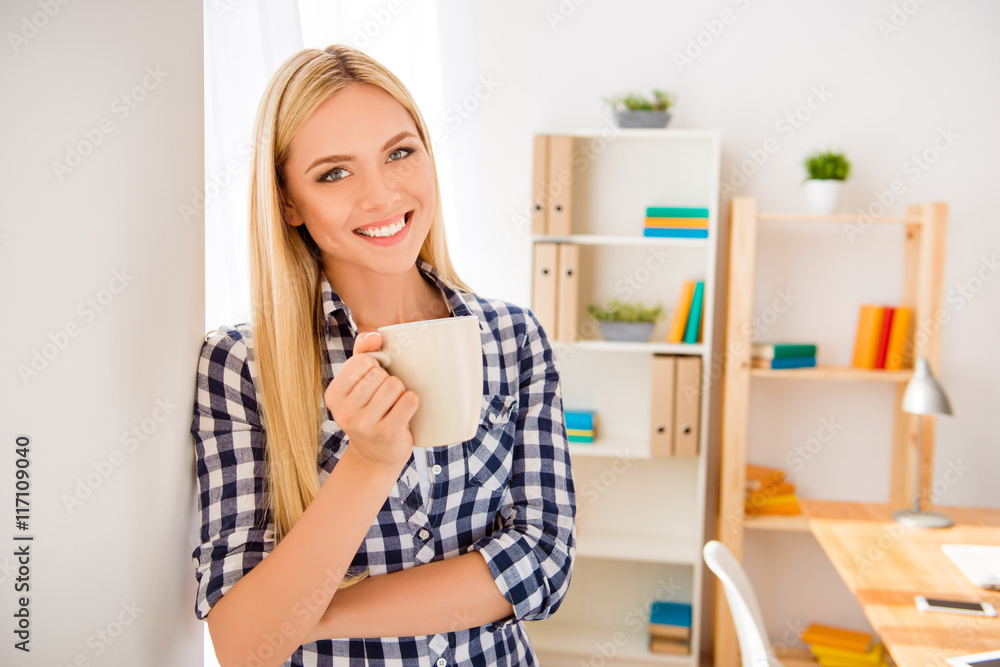 Young happy woman  having break and drinking coffee