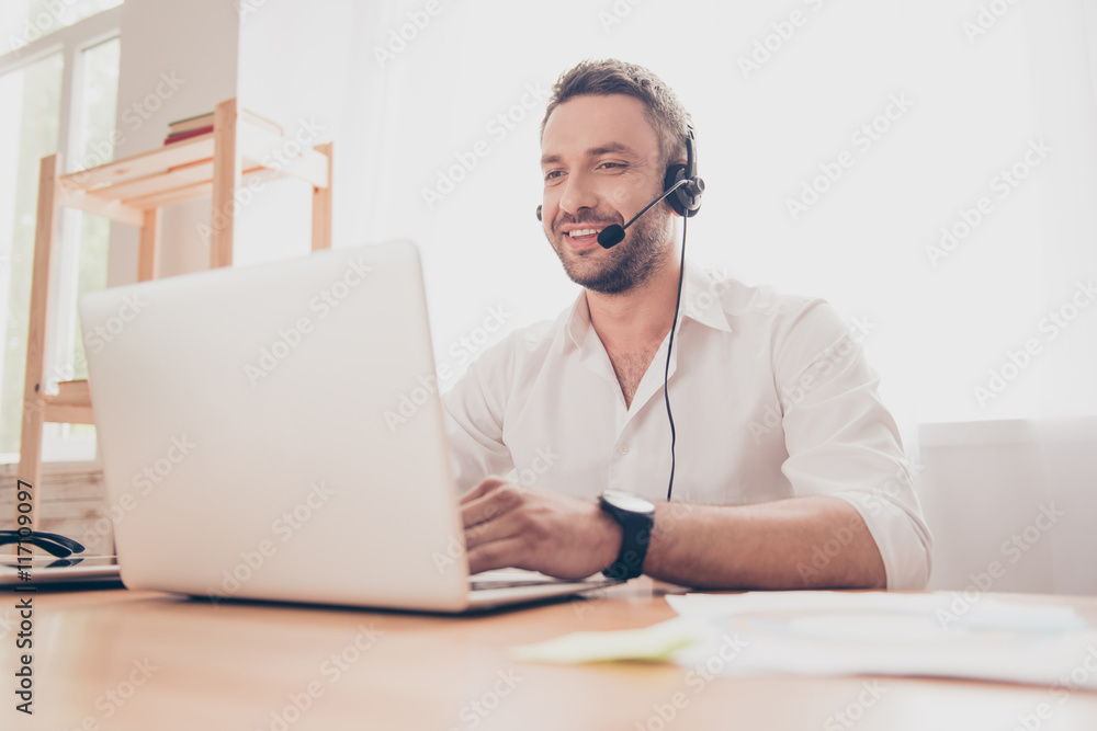 Portrait of handsome smiling operator with head-phones and lapto Portrait of handsome smiling operator with head-phones and lapto