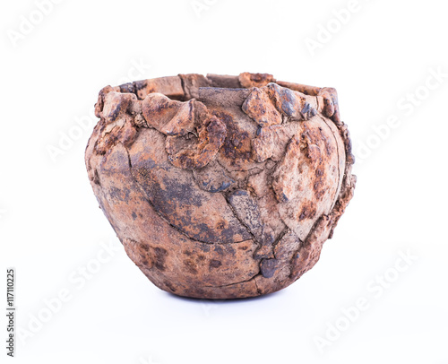 Prehistoric iron pot on a white background