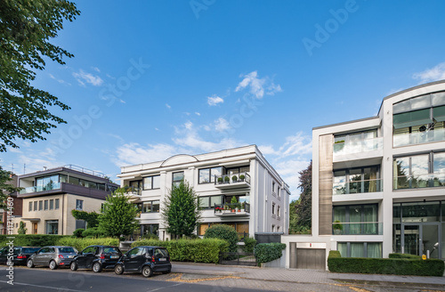 Architectural buildings along the Alster canal in Hamburg Germany 
Luxury old mansions Winterhude neighbourhood against blue sky on sunny summer day, image for real estate agent business realtor blog