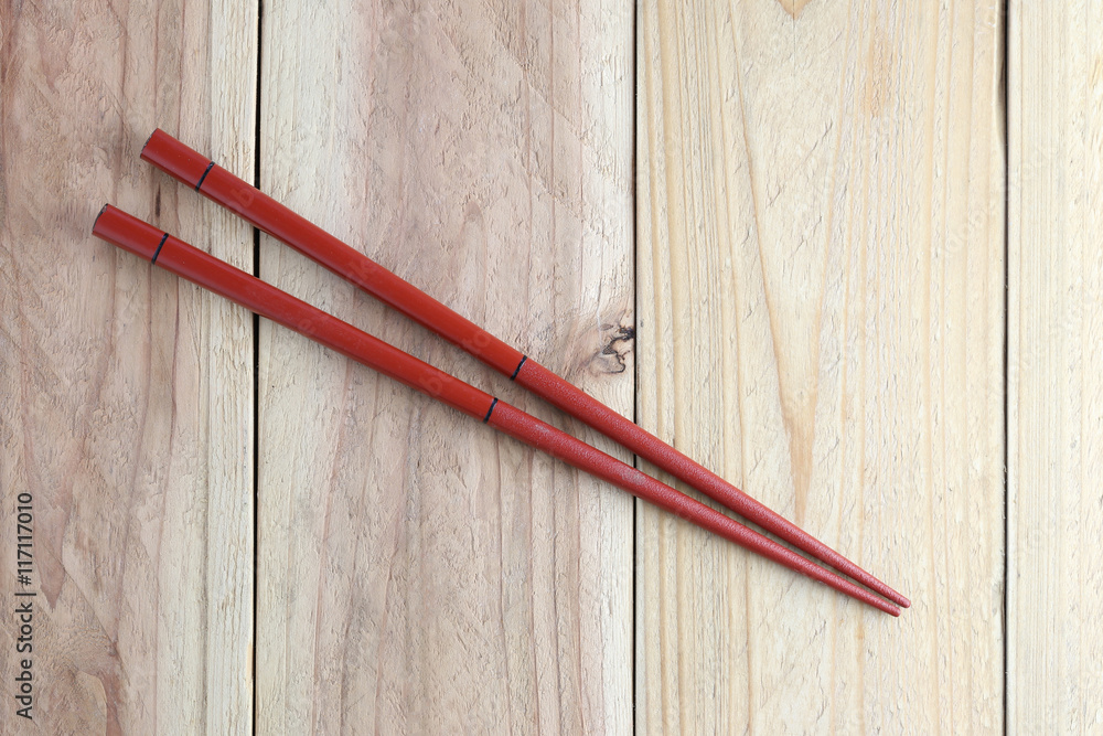 Red chopsticks spoon on wood floor. Red chopsticks spoon on wood floor.