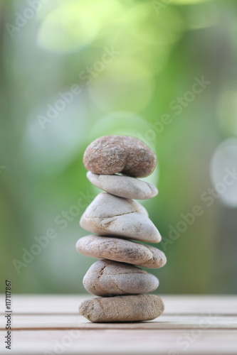 balance rock or zen stones on wooden floor and have nature green
