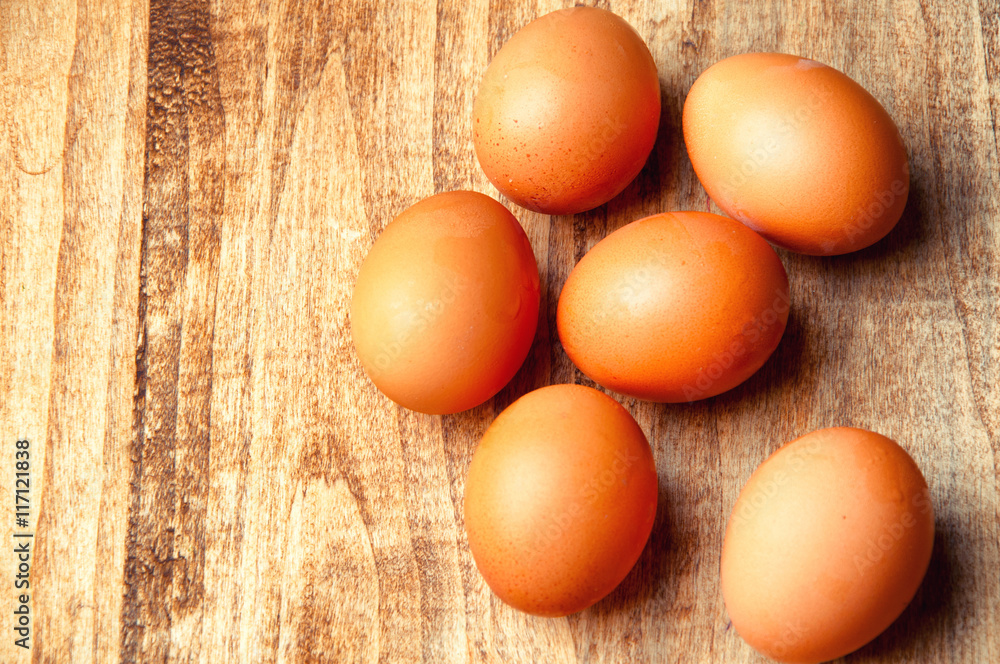 The image of eggs on a wooden table. The image of eggs on a wooden table.