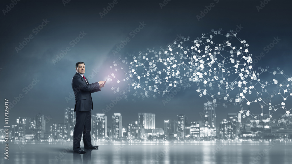 Businessman use tablet pc . Mixed media