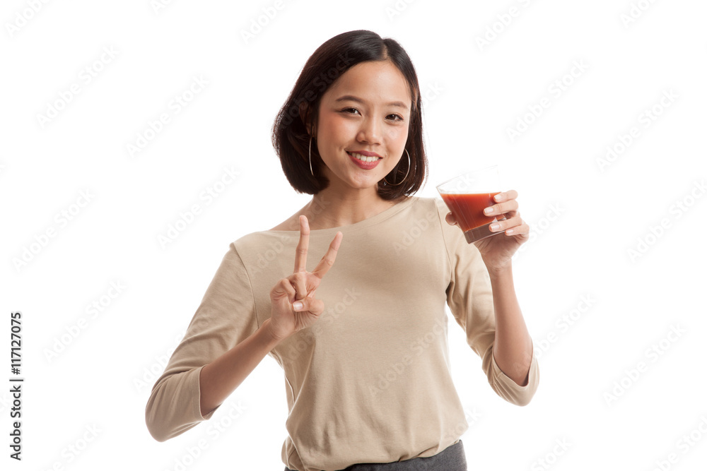 Asian woman show victory sign with tomato juice Asian woman show victory sign with tomato juice
