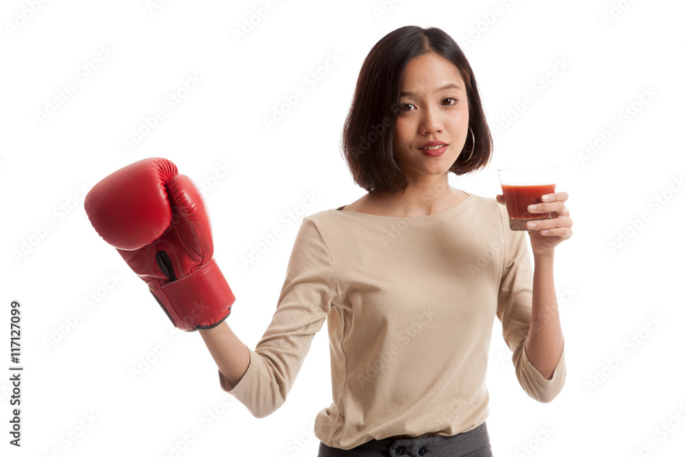 Young Asian business woman with tomato juice and boxing glove Young Asian business woman with tomato juice and boxing glove
