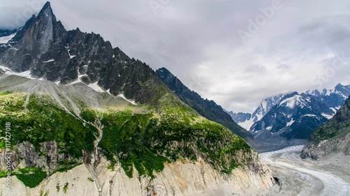 Timelapse of Drus , Mer de Glace glacier and Grandes Jorasses in the Mont Blanc massif during the cloud and rainy day in summer at Chamonix, French Alps photo