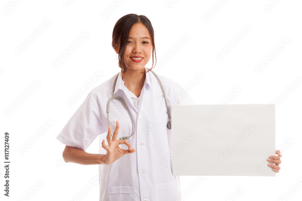 Asian female doctor show OK sign with blank sign Asian female doctor show OK sign with blank sign
