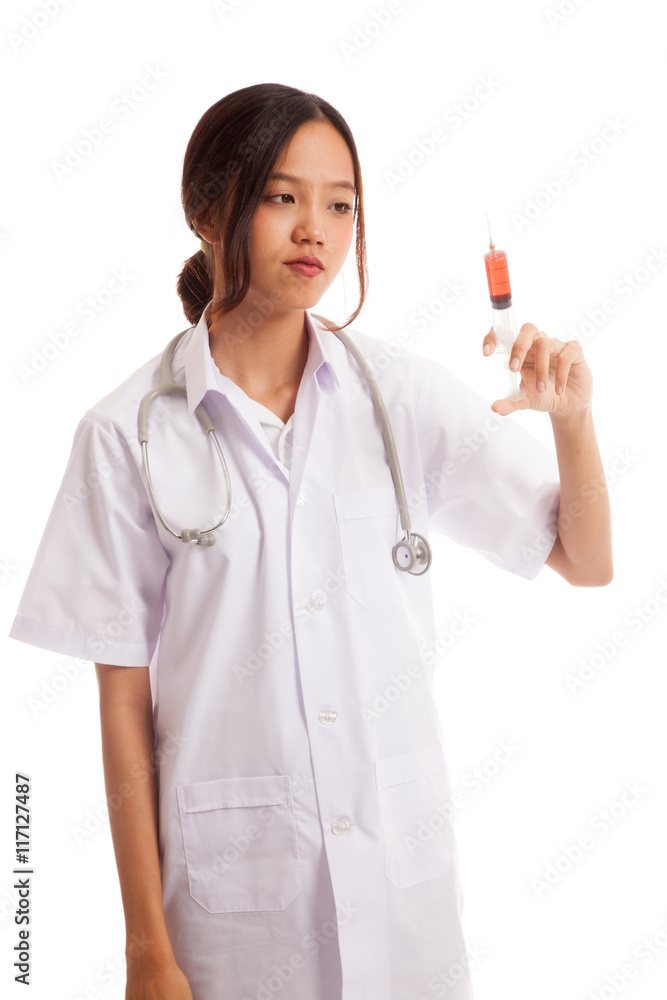 Young Asian female doctor look at syringe Young Asian female doctor look at syringe