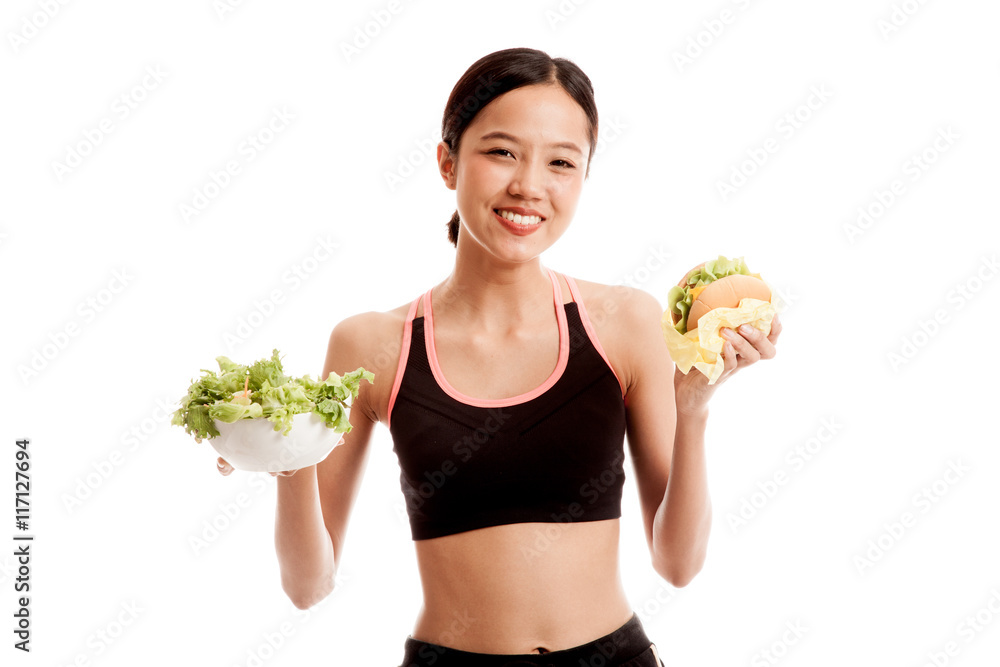 Beautiful Asian healthy girl with salad and hamburger Beautiful Asian healthy girl with salad and hamburger