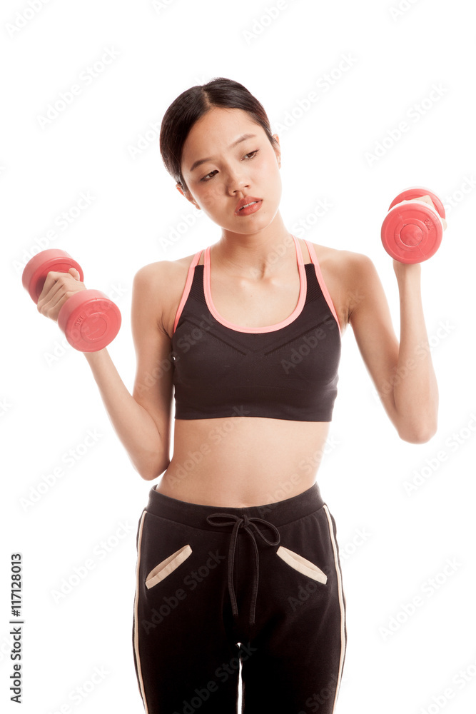 Tired Asian healthy girl exercise with dumbbell Tired Asian healthy girl exercise with dumbbell