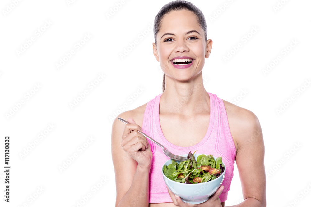 Fit woman with a bowl of salad and vegetables Fit woman with a bowl of salad and vegetables