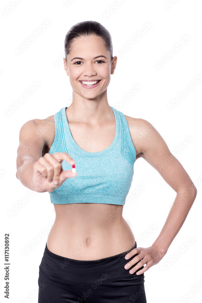 Slim caucasian model showing antibiotic pill Slim caucasian model showing antibiotic pill