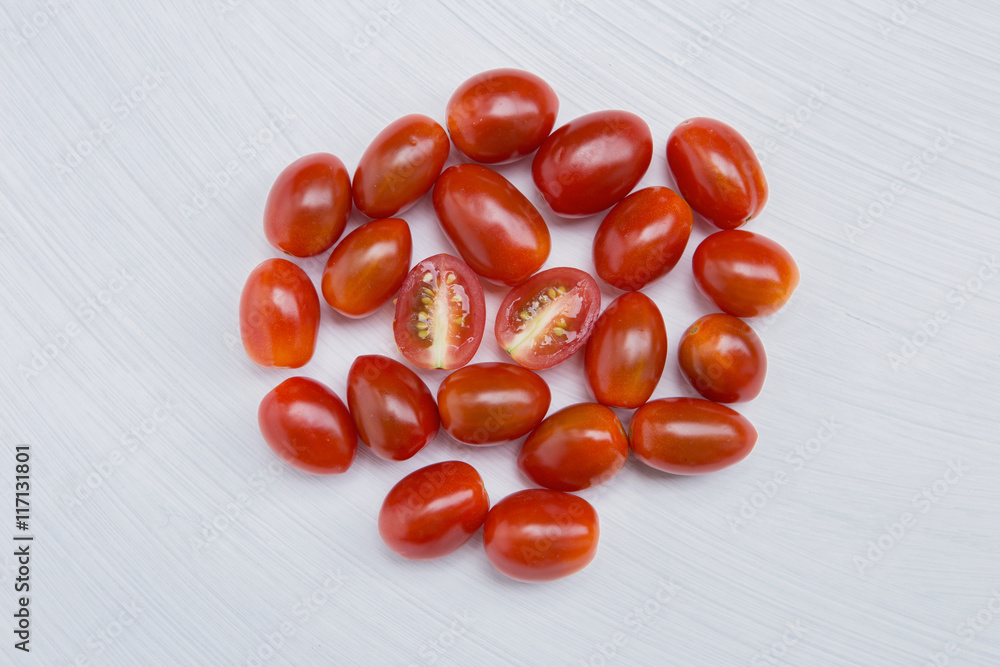 Fresh cherry tomato on white texture background Fresh cherry tomato on white texture background