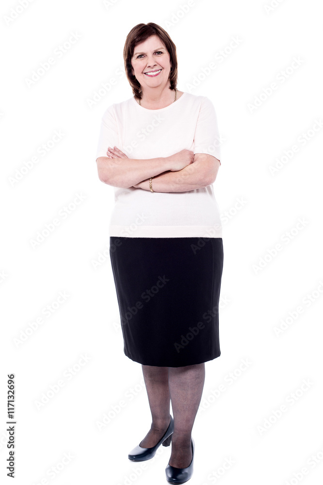 Fototapeta premium Full length portrait of a senior woman, arms crossed.