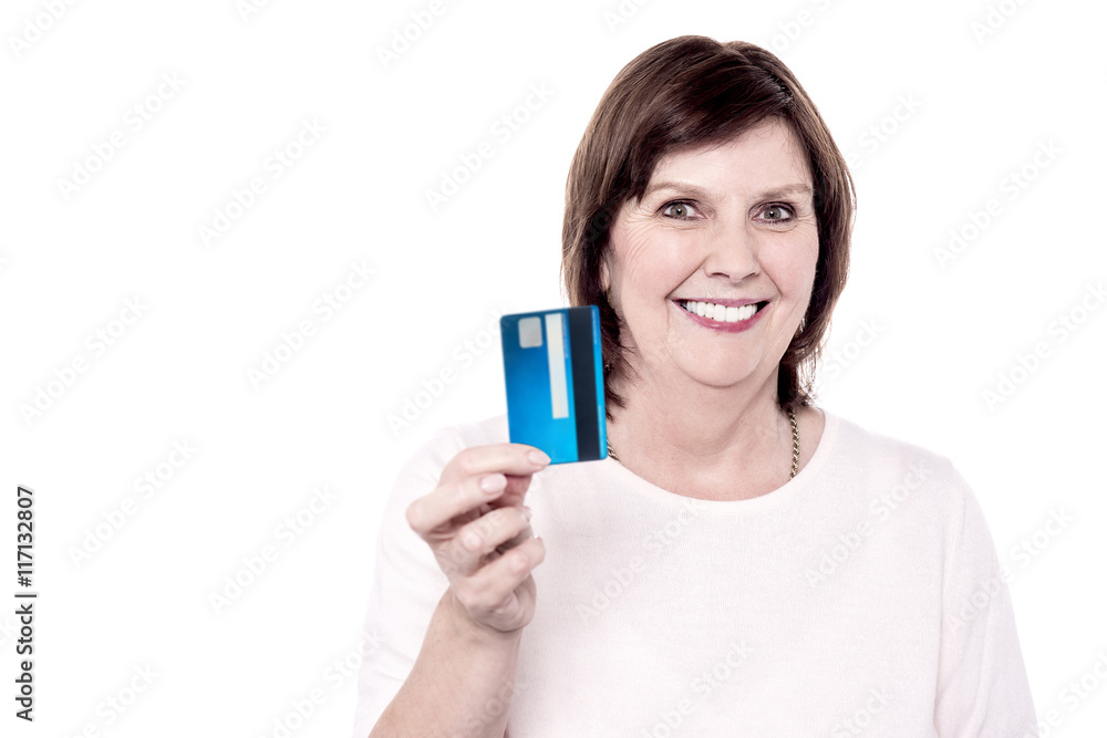 Senior smiling woman holding debit card Senior smiling woman holding debit card