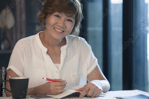 asian woman smiling face ,education and working at home concept photo
