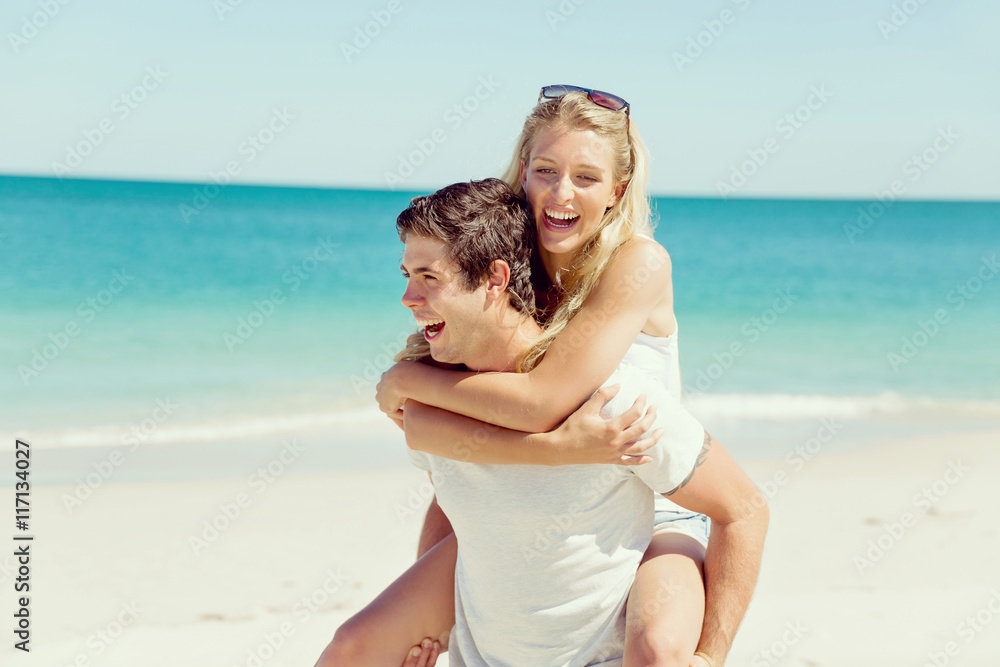 Portrait of man carrying girlfriend on his back