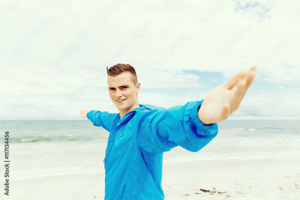 Young man in sport wear with outstretched arms Young man in sport wear with outstretched arms