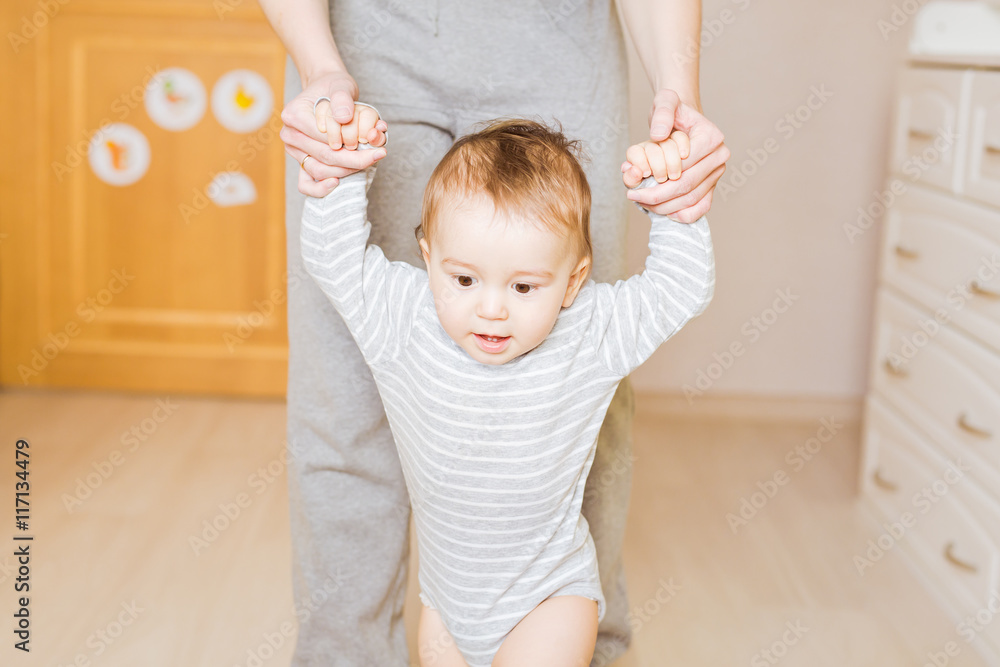 little boy first steps with the help of mother little boy first steps with the help of mother