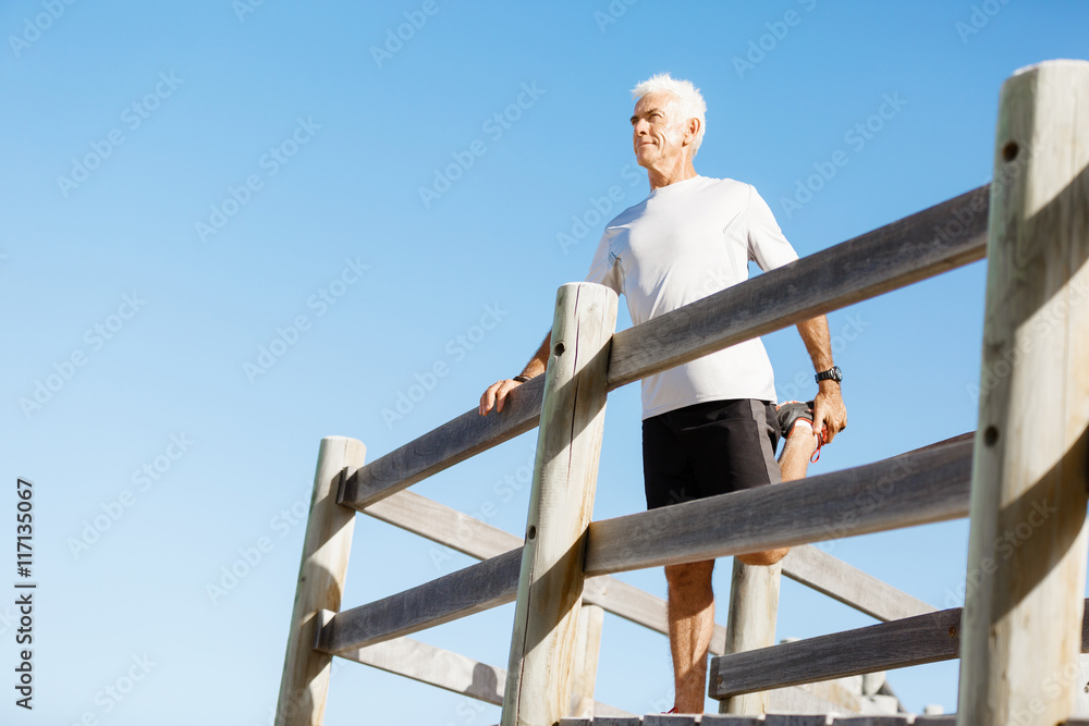 Man standing on beach in sports wear Man standing on beach in sports wear