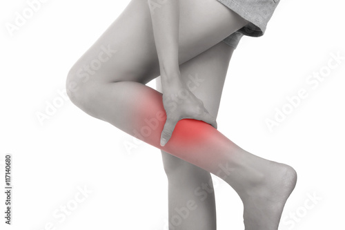 Woman with calf feeling pain on white background