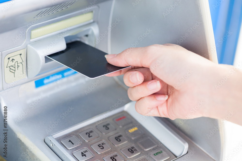 Close up hand inserting card into ATM. Close up hand inserting card into ATM.