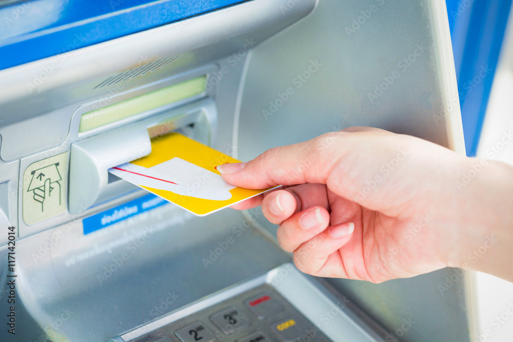 Close up hand inserting card into ATM. Close up hand inserting card into ATM.