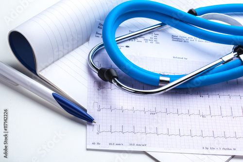 Stethoscope on cardiogram sheet