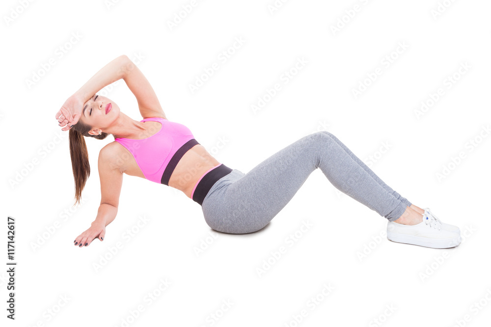 Woman at gym sitting down tired after workout
