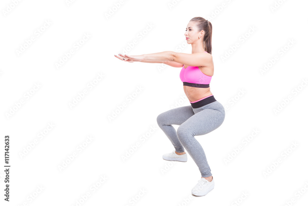 Fit girl working out doing squats with hands up Fit girl working out doing squats with hands up