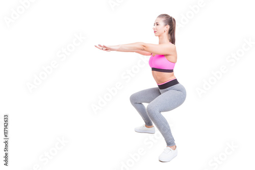 Fit girl working out doing squats with hands up
