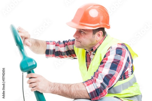 Workman fixing the grass trimming machine