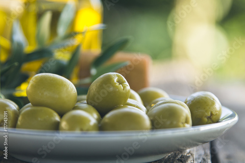 dish of olives on wooden background