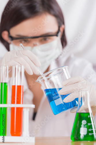 Female medical or scientific researcher using test tube on labor
