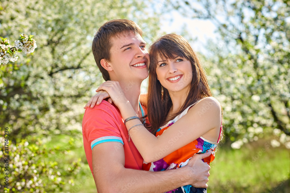 Fototapeta premium Young couple enjoying in blooming garden
