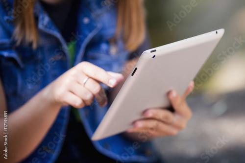 Female hands holding digital tablet. Doing business the modern w