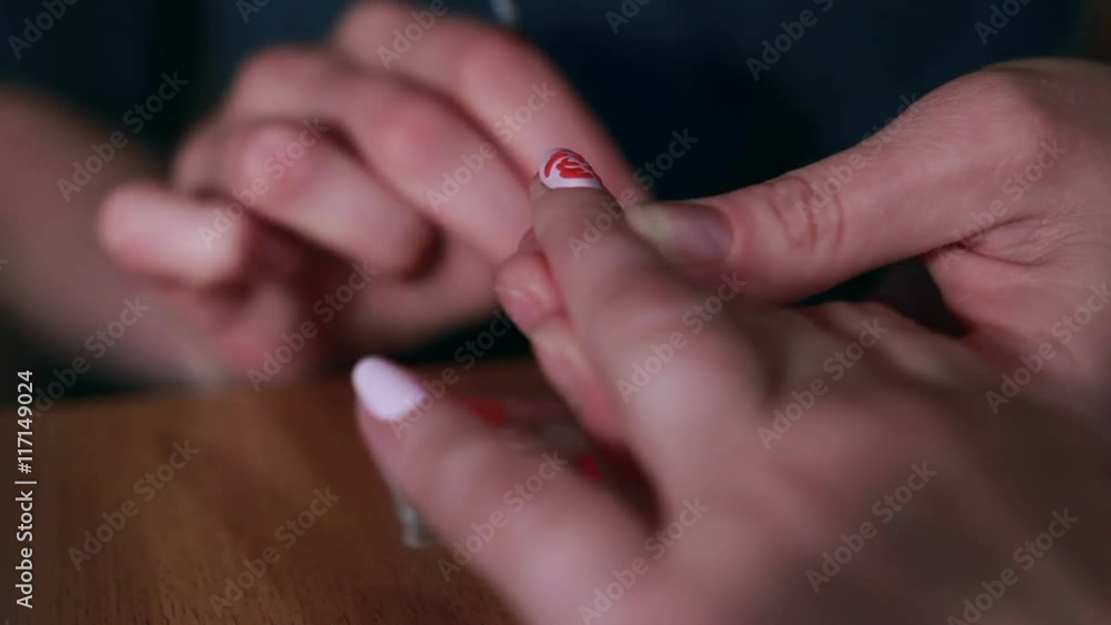 Woman in a Beauty Salon receiving a manicure Woman in a Beauty Salon receiving a manicure