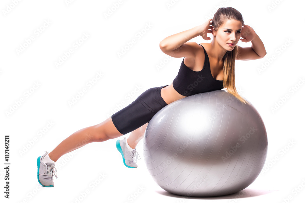 Woman making exercise with pilates ball, against white background Woman making exercise with pilates ball, against white background