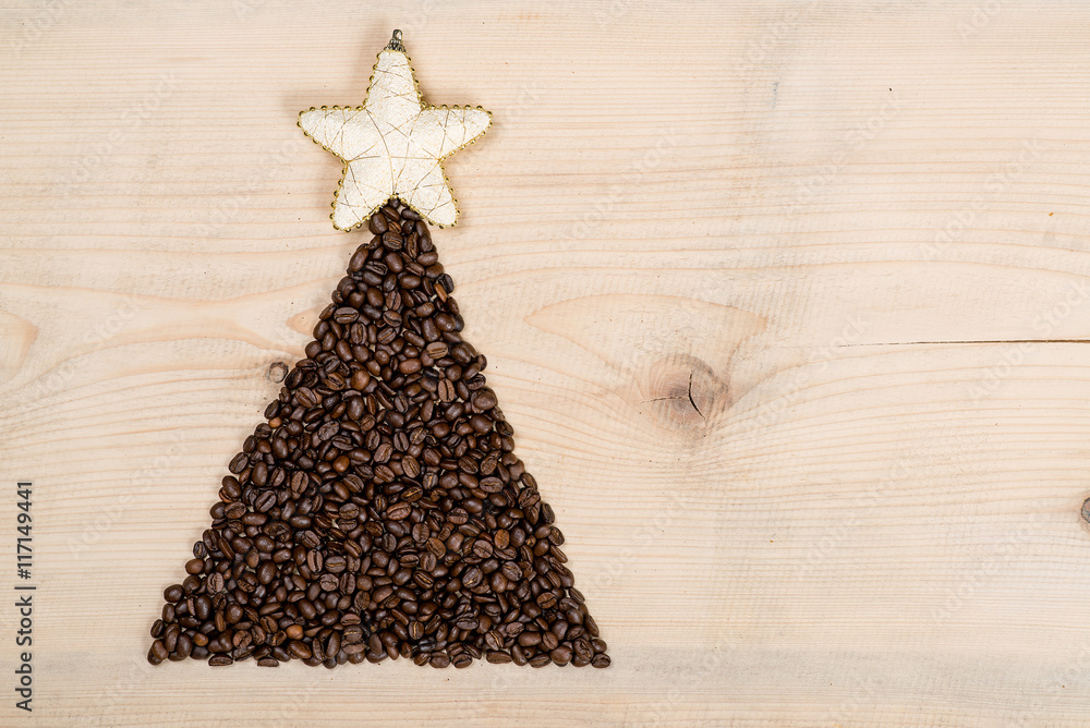 Christmas tree made from coffee beans on wooden background. Top Christmas tree made from coffee beans on wooden background. Top